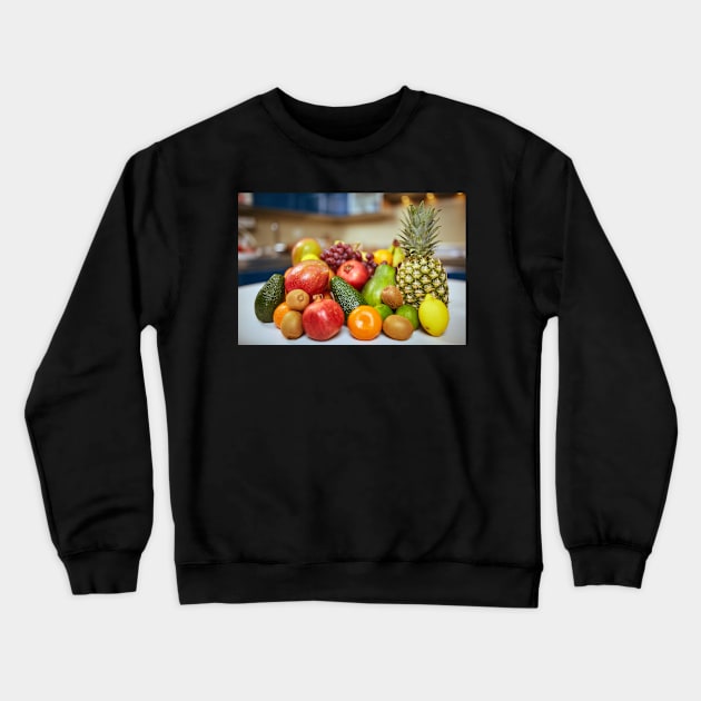 Exotic fruits on the table in the kitchen Crewneck Sweatshirt by naturalis